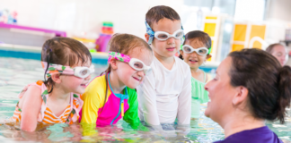 New at Bradley Fair: Why Moms Are Already Talking About Emler Swim School A group of children in a pool taking swimming lessons