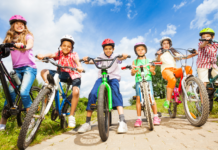 Bike Safety for Kids: What Every Parent Should Know kids wearing bike helmets and riding bicycles on a sunny day